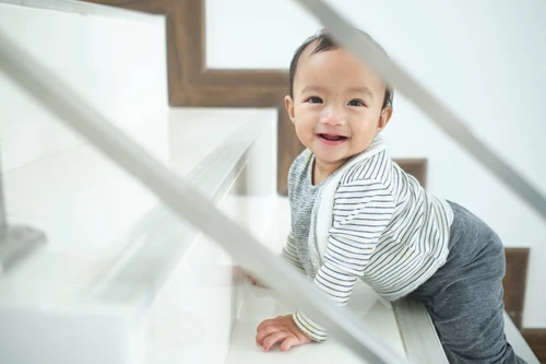 Bayi sedang merangkak naik ke atas tangga.